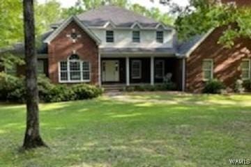 traditional-style home with a front lawn and a porch