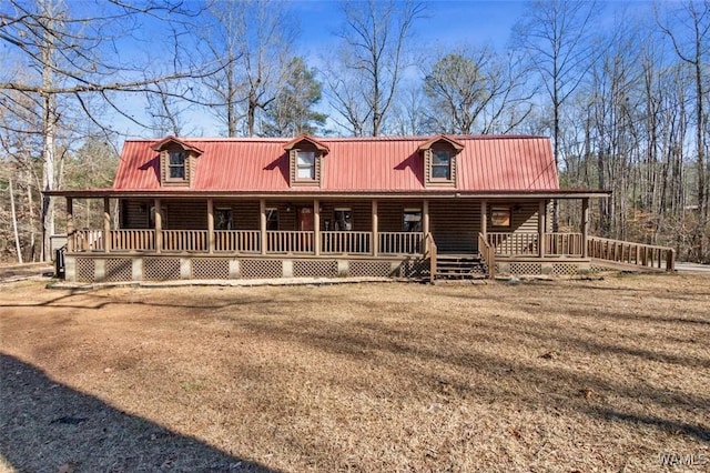 log cabin with a porch and a front yard