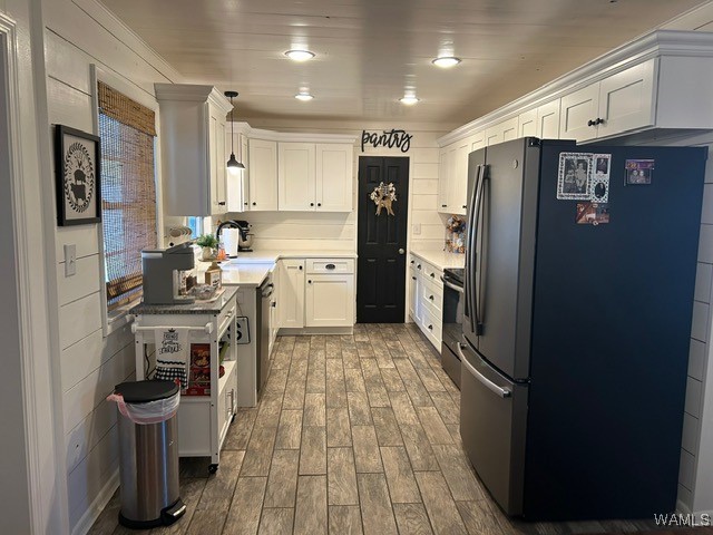 kitchen featuring white cabinetry, hardwood / wood-style floors, sink, and appliances with stainless steel finishes