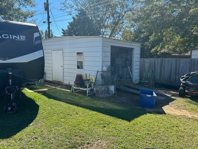 view of outbuilding featuring a yard