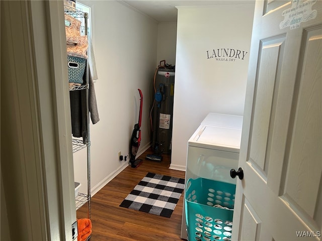 washroom with washer and dryer, dark wood-type flooring, and water heater