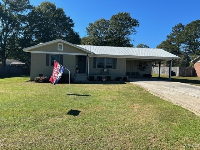 ranch-style home with a carport and a front yard