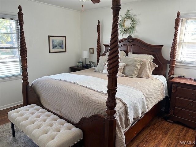 bedroom with dark hardwood / wood-style floors, ceiling fan, and crown molding