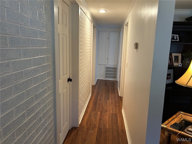 corridor featuring crown molding and dark wood-type flooring