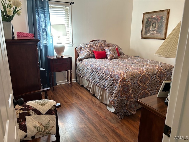 bedroom with dark wood-type flooring