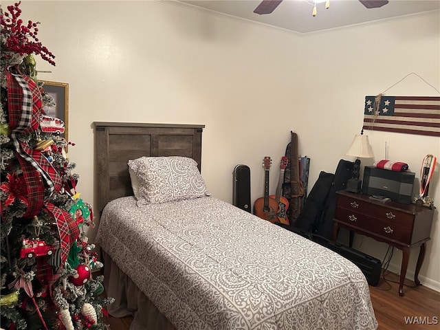 bedroom featuring hardwood / wood-style floors, ceiling fan, and ornamental molding