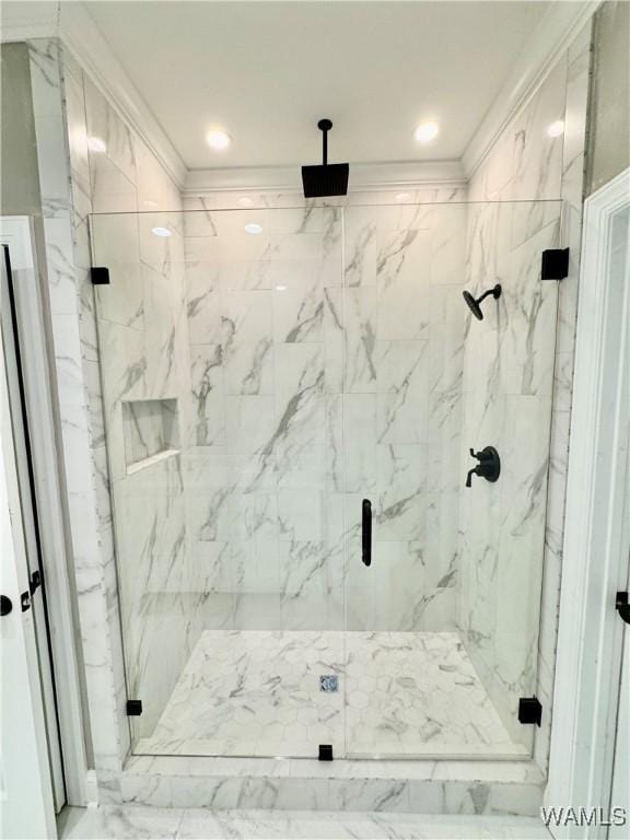 full bath with a marble finish shower and crown molding