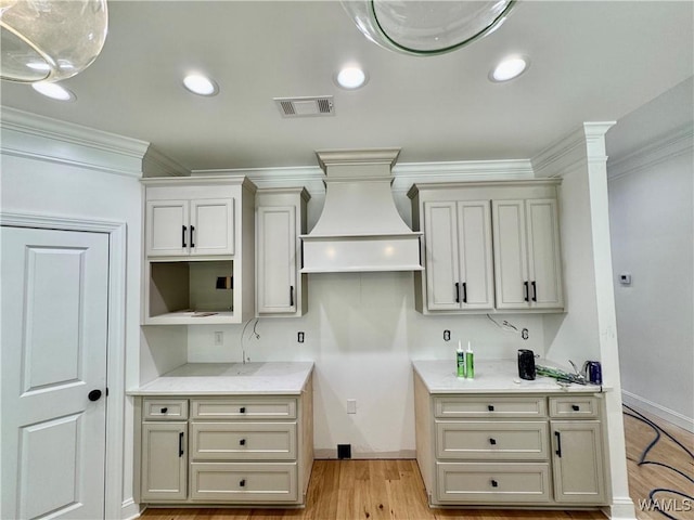 kitchen featuring recessed lighting, visible vents, light wood-style floors, light countertops, and ornamental molding