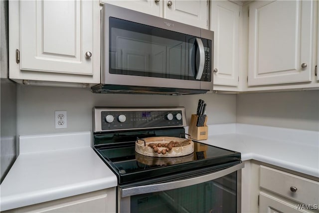 kitchen featuring appliances with stainless steel finishes and white cabinets