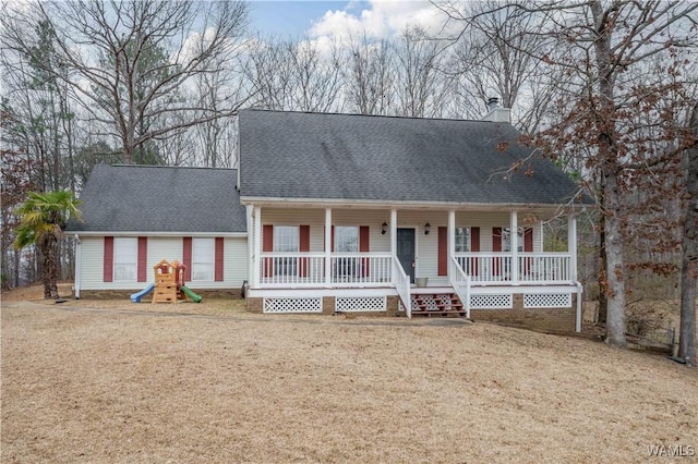 cape cod home with a porch, a front yard, and a playground