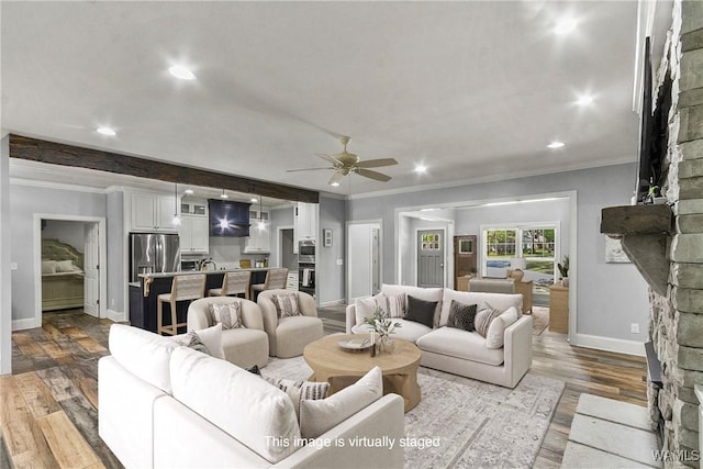 10649 Legacy Point Dr, Northport, AL 35475 - living area with ceiling fan, dark wood finished floors, ornamental molding, recessed lighting, and a stone fireplace