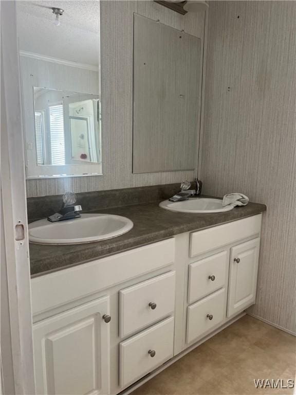 12443 Reed Simpson Rd, Northport, AL 35475 - bathroom featuring double vanity, ornamental molding, wallpapered walls, ceiling fan, and a textured ceiling