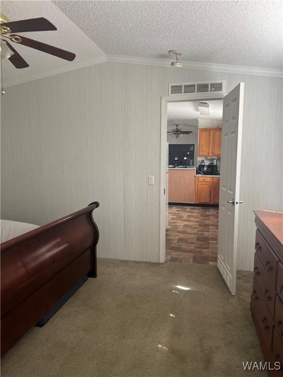 12443 Reed Simpson Rd, Northport, AL 35475 - bedroom with ornamental molding, a textured ceiling, ceiling fan, carpet, and lofted ceiling