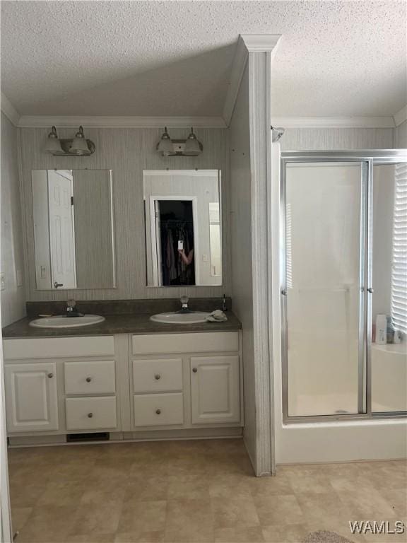 12443 Reed Simpson Rd, Northport, AL 35475 - full bathroom with ornamental molding, a textured ceiling, a stall shower, double vanity, and tile patterned floors