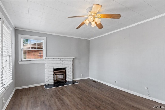 unfurnished living room featuring ornamental molding, a ceiling fan, a brick fireplace, wood finished floors, and baseboards