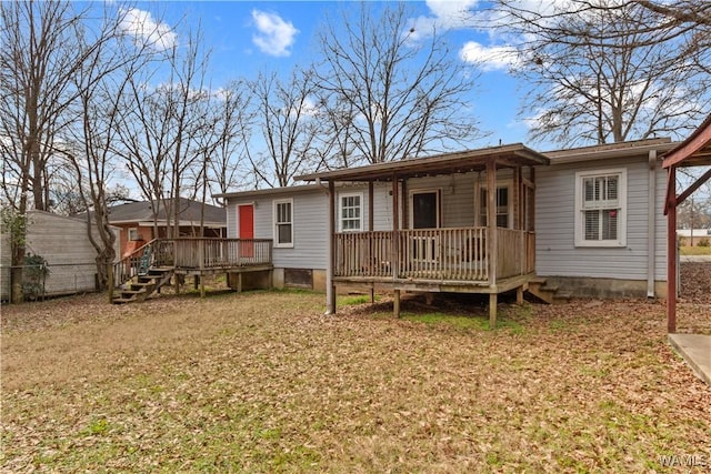 back of house featuring a yard and a deck