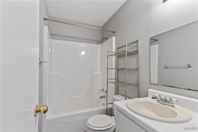 bathroom featuring toilet, bathtub / shower combination, a textured ceiling, and vanity