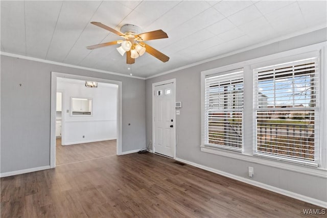 entrance foyer with crown molding, visible vents, a ceiling fan, wood finished floors, and baseboards