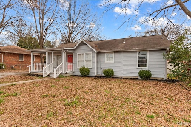 ranch-style home with a chimney, a front lawn, and a porch