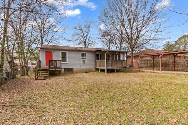 rear view of house featuring a fenced backyard and a yard