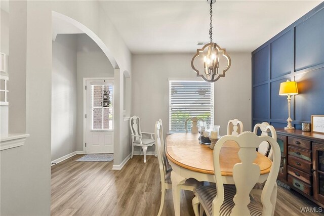 2757 Lily Cir, Northport, AL 35473 - dining area with arched walkways, plenty of natural light, a chandelier, and light wood finished floors
