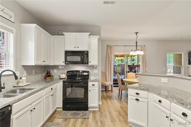 2757 Lily Cir, Northport, AL 35473 - kitchen featuring black appliances, light wood-type flooring, decorative backsplash, and white cabinets