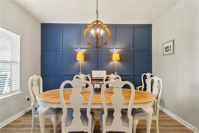 2757 Lily Cir, Northport, AL 35473 - dining room with a decorative wall, a chandelier, light wood-style flooring, and healthy amount of natural light
