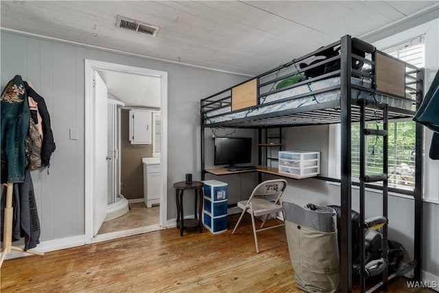 bedroom with wood finished floors and visible vents
