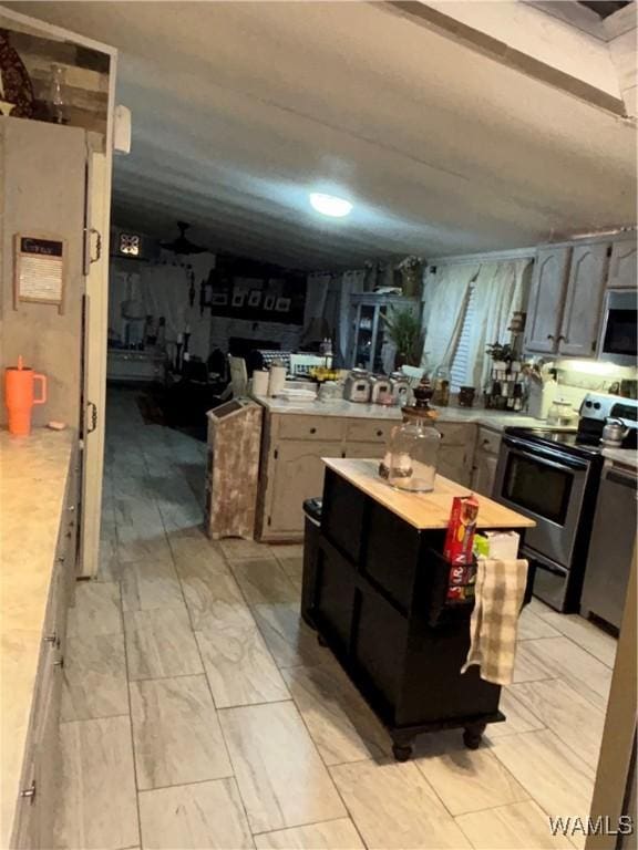 743 Greentree Dr, West Blocton, AL 35188 - kitchen with electric range, light countertops, and a kitchen island
