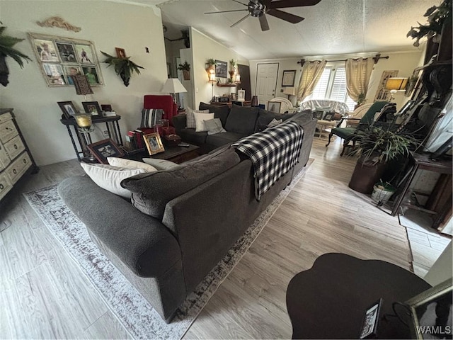 living area with a ceiling fan and wood finished floors