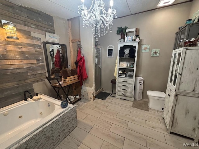 full bath with a chandelier, a jetted tub, toilet, and wood walls