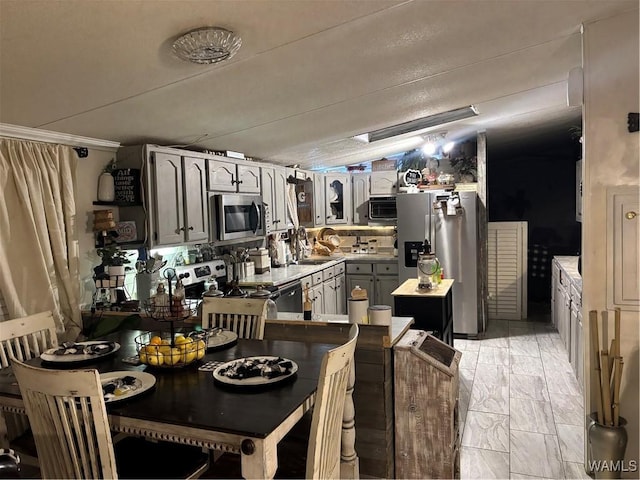 kitchen with stainless steel appliances, light marble finish floors, light countertops, and glass insert cabinets