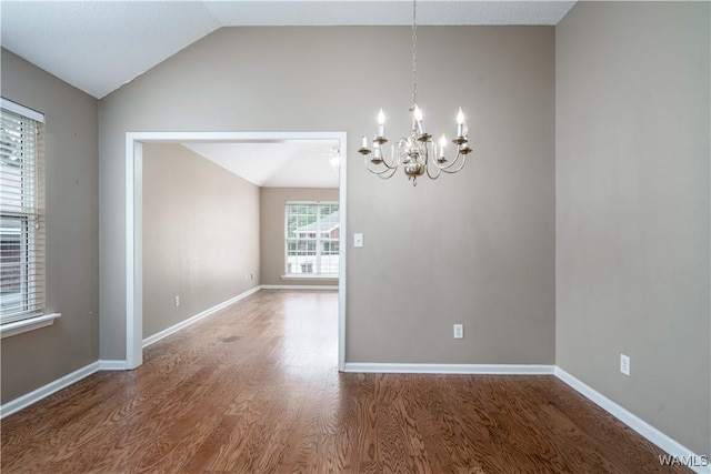 6128 Covington Villas Dr, Tuscaloosa, AL 35405 - spare room featuring vaulted ceiling, a chandelier, and wood finished floors