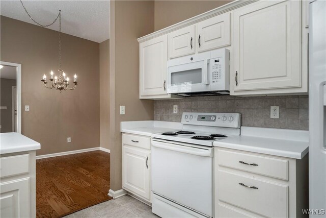 6128 Covington Villas Dr, Tuscaloosa, AL 35405 - kitchen featuring white appliances, light countertops, a chandelier, backsplash, and vaulted ceiling