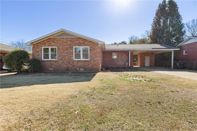 ranch-style home featuring a front yard and a carport