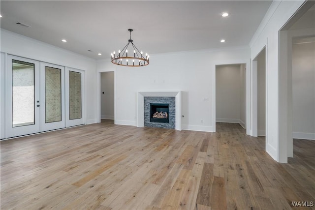 407 Edgefield Mews Cir, Tuscaloosa, AL 35406 - unfurnished living room with ornamental molding, light wood finished floors, a chandelier, recessed lighting, and a stone fireplace