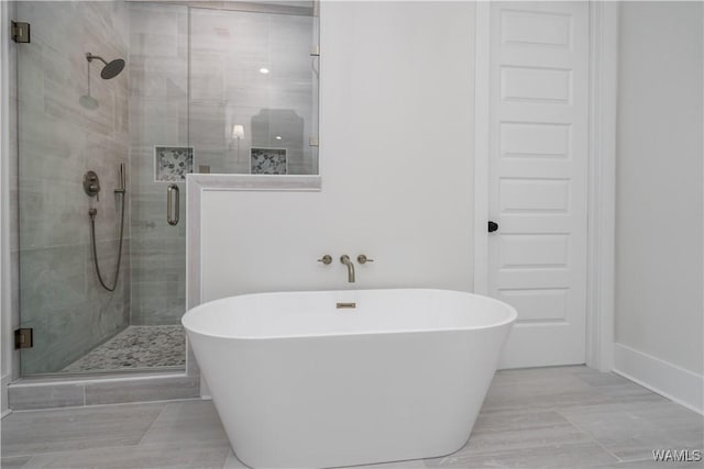 407 Edgefield Mews Cir, Tuscaloosa, AL 35406 - bathroom featuring a freestanding bath and a stall shower