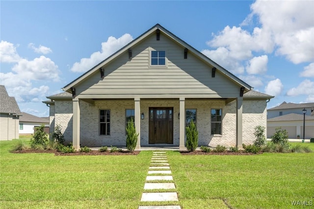407 Edgefield Mews Cir, Tuscaloosa, AL 35406 - view of front of house with a front lawn, covered porch, and brick siding