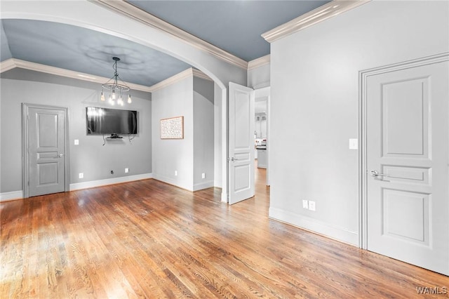 120 Magnolia Cir, Centreville, AL 35042 - unfurnished living room with arched walkways, wood finished floors, and ornamental molding