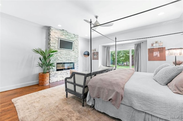 120 Magnolia Cir, Centreville, AL 35042 - bedroom with wood finished floors, a stone fireplace, ornamental molding, recessed lighting, and access to exterior