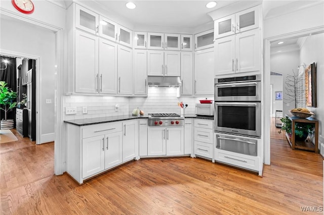 120 Magnolia Cir, Centreville, AL 35042 - kitchen with a warming drawer, stainless steel appliances, white cabinets, dark countertops, and light wood-style floors
