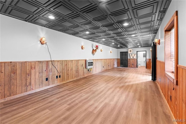 120 Magnolia Cir, Centreville, AL 35042 - unfurnished living room featuring a wainscoted wall, heating unit, an ornate ceiling, light wood-style floors, and wooden walls