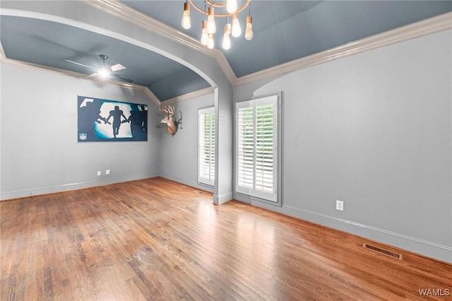120 Magnolia Cir, Centreville, AL 35042 - empty room featuring lofted ceiling, crown molding, wood finished floors, a chandelier, and arched walkways