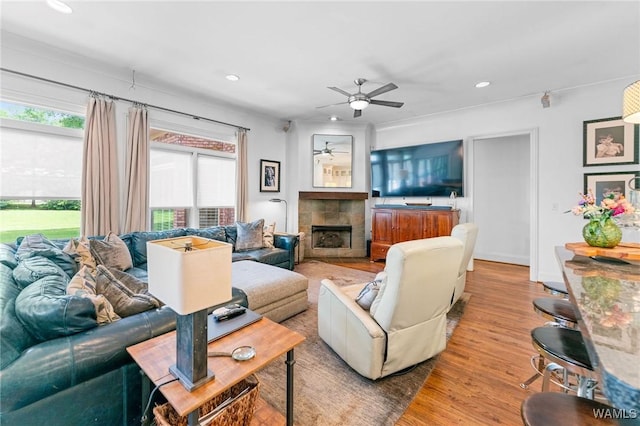 120 Magnolia Cir, Centreville, AL 35042 - living room featuring a ceiling fan, a tiled fireplace, wood finished floors, and recessed lighting
