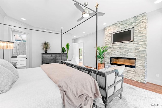 120 Magnolia Cir, Centreville, AL 35042 - bedroom featuring multiple windows, wood finished floors, a fireplace, recessed lighting, and ensuite bath