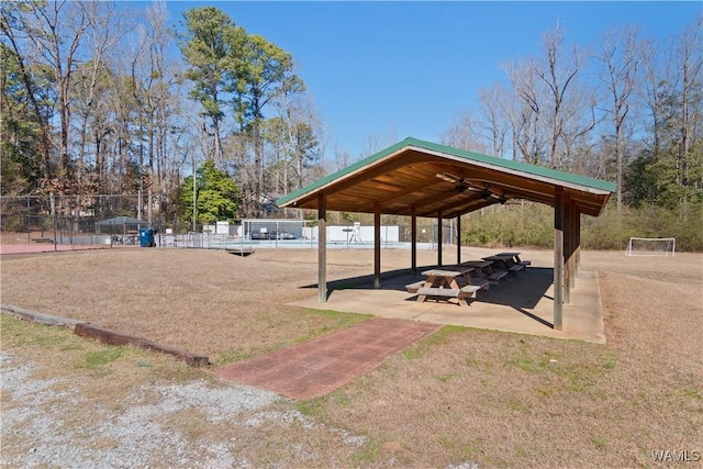view of property's community featuring a gazebo, fence, and a carport