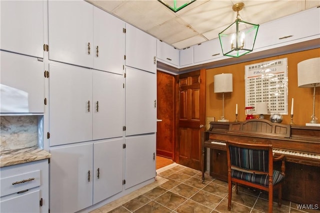 4704 Oneida Ave, Northport, AL 35473 - kitchen with white cabinets and pendant lighting
