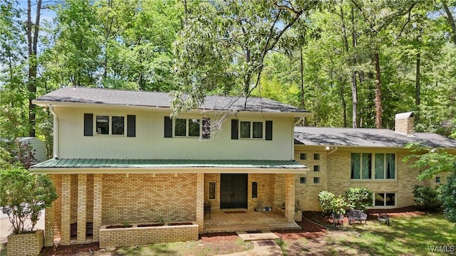 4704 Oneida Ave, Northport, AL 35473 - view of front of house with brick siding, a chimney, and covered porch