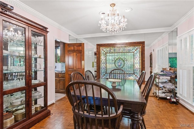 dining room with crown molding and a chandelier