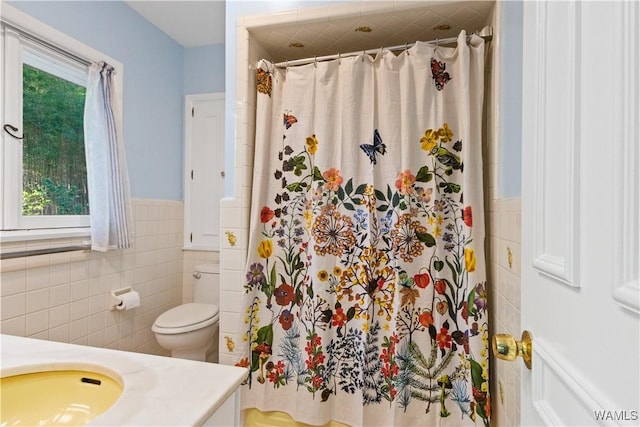 4704 Oneida Ave, Northport, AL 35473 - bathroom with tile walls, a wainscoted wall, vanity, curtained shower, and toilet